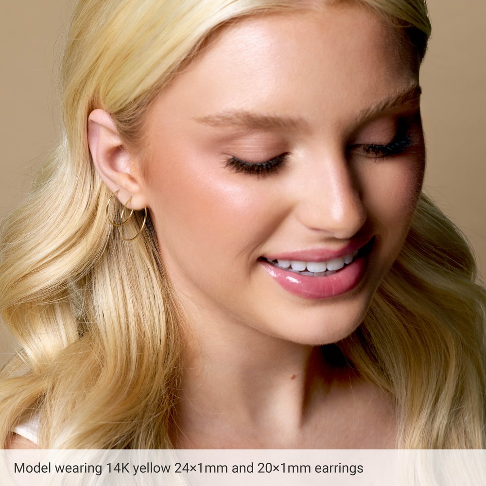 Close-up of a model wearing 14K yellow gold earrings with text overlay.